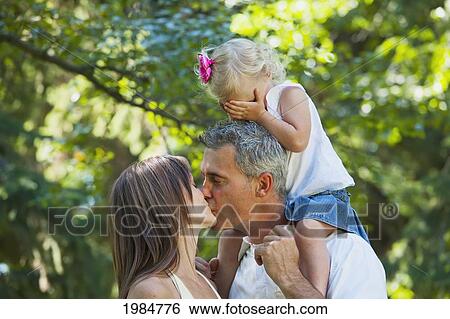 husband and wife kissing in front of toddler; edmonton alberta canada View Large Photo Image Stock Photograph - husband and wife kissing in front of toddler; edmonton alberta canada. Fotosearch