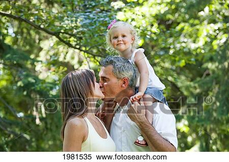 husband and wife kissing in front of toddler; edmonton alberta canada View Large Photo Image Stock Photography - husband and wife kissing in front of toddler; edmonton alberta canada. Fotosearch