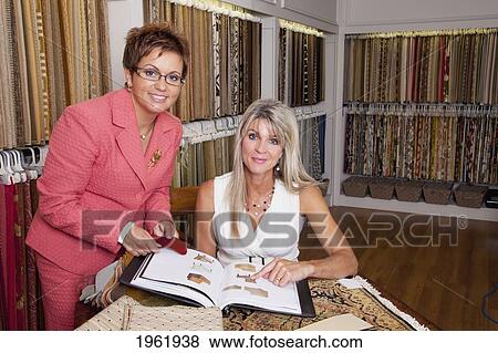 interior designer consulting with client on remodelling of home at a showroom; edmonton, alberta, canada View Large Photo Image Stock Photo - interior designer consulting with client on remodelling of home at a showroom; edmonton, alberta, canada. Fotosearch