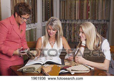 interior designer consulting with client and daughter on remodelling of home; edmonton, alberta, canada View Large Photo Image Stock Photograph - interior designer consulting with client and daughter on remodelling of home; edmonton, alberta, canada. Fotosearch