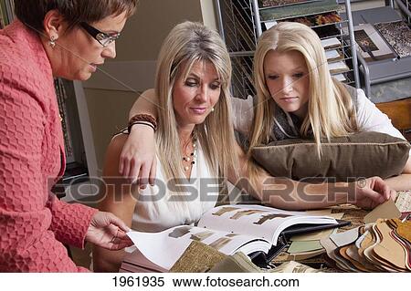 interior designer consulting with client and daughter on remodelling of home; edmonton, alberta, canada View Large Photo Image Stock Photography - interior designer consulting with client and daughter on remodelling of home; edmonton, alberta, canada. Fotosearch