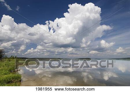 Stock Photography - large cumulus clouds over anglin lake; saskatchewan canada. Fotosearch