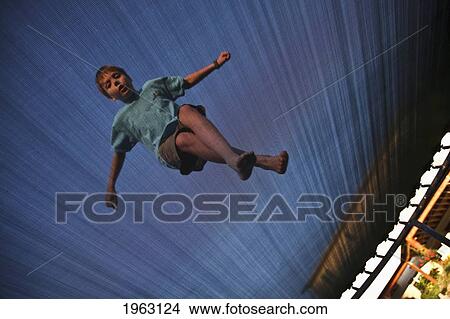 low angle of boy on trampoline; ferndale, washington, united states of america View Large Photo Image Picture - low angle of boy on trampoline; ferndale, washington, united states of america. Fotosearch