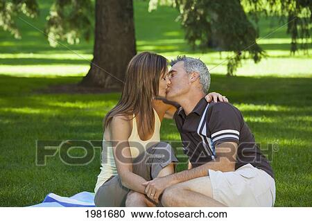 married couple kissing in a park; edmonton alberta canada View Large Photo Image Stock Image - married couple kissing in a park; edmonton alberta canada. Fotosearch