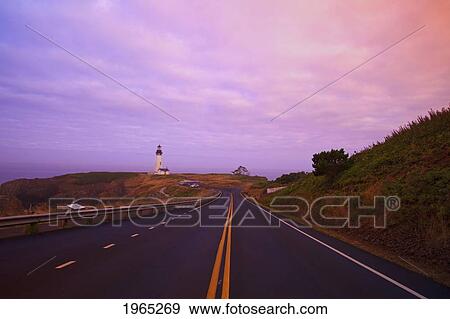 Stock Photo - morning light over yaquina head lighthouse and the highway; newport oregon united states of america. Fotosearch