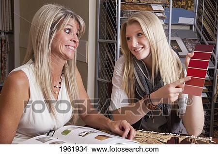 mother and daughter discussing colours and samples for remodelling of home; edmonton, alberta, canada View Large Photo Image Picture - mother and daughter discussing colours and samples for remodelling of home; edmonton, alberta, canada. Fotosearch