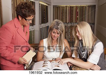 mother and daughter discussing colours and samples for remodelling of home with an interior designer; edmonton, alberta, canada View Large Photo Image Stock Image - mother and daughter discussing colours and samples for remodelling of home with an interior designer; edmonton, alberta, canada. Fotosearch