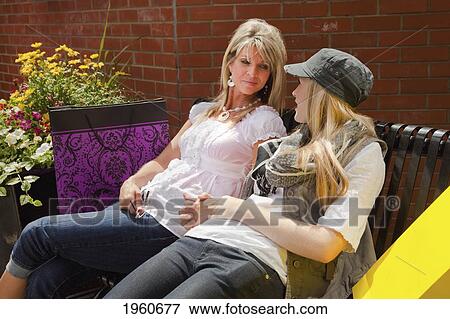 mother and daughter resting after shopping; edmonton, alberta, canada View Large Photo Image Stock Photo - mother and daughter resting after shopping; edmonton, alberta, canada. Fotosearch