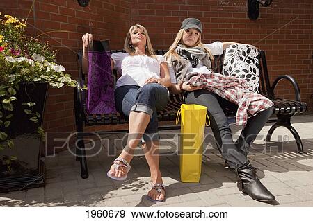 mother and daughter resting after shopping; edmonton, alberta, canada View Large Photo Image Stock Photo - mother and daughter resting after shopping; edmonton, alberta, canada. Fotosearch