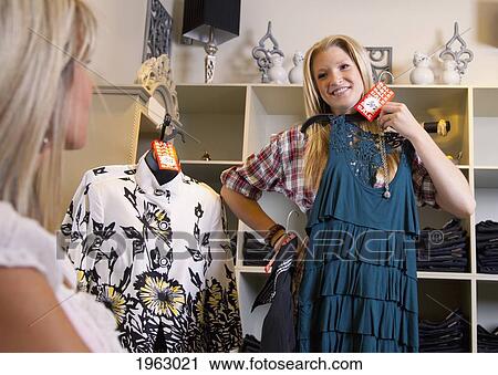 Stock Image - mother and daughter shopping for clothes at a boutique; edmonton, alberta, canada. Fotosearch
