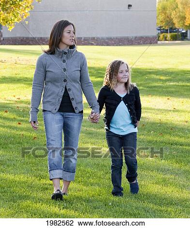 mother and daughter walking in a park by the school; beaumont alberta canada View Large Photo Image Stock Image - mother and daughter walking in a park by the school; beaumont alberta canada. Fotosearch