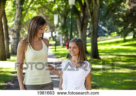 mother and daughter walking together in the park; edmonton alberta canada View Large Photo Image Stock Image - mother and daughter walking together in the park; edmonton alberta canada. Fotosearch