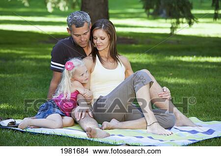 Picture - mother and father with daughter in a park; edmonton alberta canada. Fotosearch