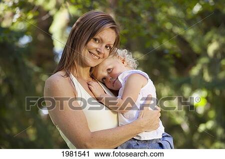 mother holding toddler in a park; edmonton alberta canada View Large Photo Image Stock Image - mother holding toddler in a park; edmonton alberta canada. Fotosearch