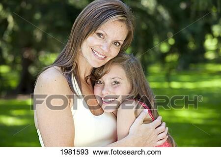 mother hugging teenage daughter in the park; edmonton alberta canada View Large Photo Image Stock Image - mother hugging teenage daughter in the park; edmonton alberta canada. Fotosearch