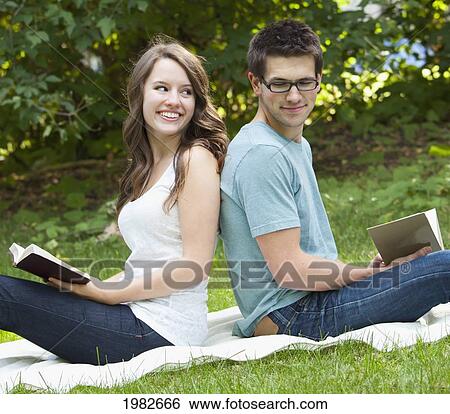 newlywed couple reading in a park together; edmonton alberta canada View Large Photo Image Stock Photograph - newlywed couple reading in a park together; edmonton alberta canada. Fotosearch