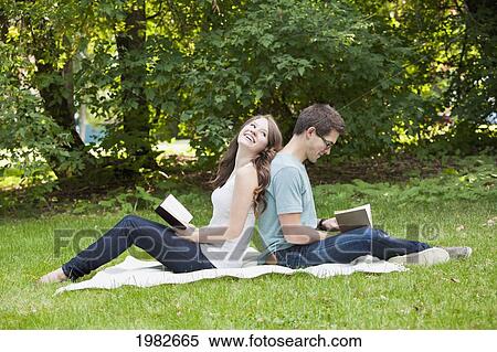 newlywed couple reading together in a park; edmonton alberta canada View Large Photo Image Stock Photography - newlywed couple reading together in a park; edmonton alberta canada. Fotosearch