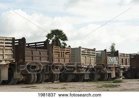 old trucks lined up; prachuap kiri khan prachuap province thailand View Large Photo Image Stock Photo - old trucks lined up; prachuap kiri khan prachuap province thailand. Fotosearch