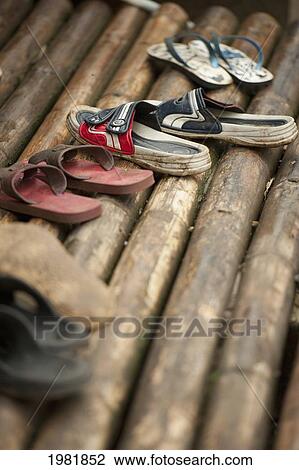 pairs of shoes on bamboo at the noh poh refugee camp; mae sot thailand View Large Photo Image Stock Image - pairs of shoes on bamboo at the noh poh refugee camp; mae sot thailand. Fotosearch