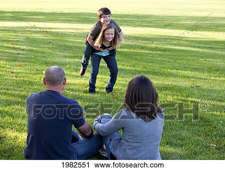 parents watching their kids playing in the park; beaumont alberta canada View Large Photo Image Stock Image - parents watching their kids playing in the park; beaumont alberta canada. Fotosearch