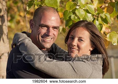 portrait of a husband and wife in a park; beaumont alberta canada View Large Photo Image Picture - portrait of a husband and wife in a park; beaumont alberta canada. Fotosearch