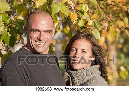portrait of a husband and wife in a park; beaumont alberta canada View Large Photo Image Stock Photo - portrait of a husband and wife in a park; beaumont alberta canada. Fotosearch