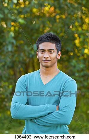 Stock Image - portrait of a teenage boy in a park setting; edmonton alberta canada. Fotosearch