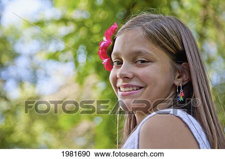 Stock Image - portrait of a teenager in a park; edmonton alberta canada. Fotosearch