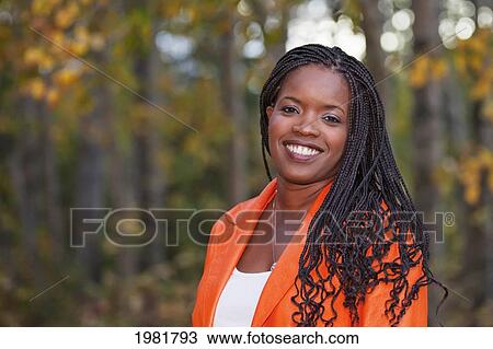 Stock Image - portrait of a woman in a park; edmonton alberta canada. Fotosearch