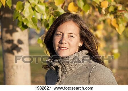 portrait of a woman in a park in autumn; beaumont alberta canada View Large Photo Image Stock Photo - portrait of a woman in a park in autumn; beaumont alberta canada. Fotosearch