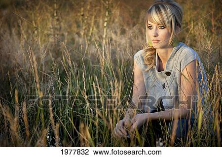portrait of a young woman in a field of tall grass; edmonton alberta canada View Large Photo Image Stock Image - portrait of a young woman in a field of tall grass; edmonton alberta canada. Fotosearch