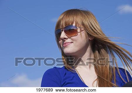portrait of a young woman wearing sunglasses; edmonton alberta canada View Large Photo Image Stock Photo - portrait of a young woman wearing sunglasses; edmonton alberta canada. Fotosearch