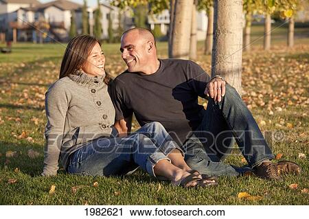 portrait of husband and wife in a park; beaumont alberta canada View Large Photo Image Stock Image - portrait of husband and wife in a park; beaumont alberta canada. Fotosearch