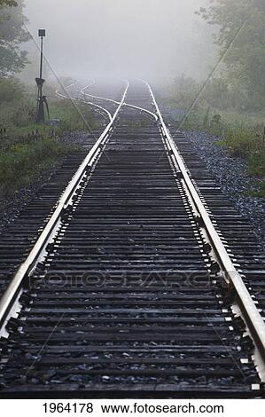 railway track in the early morning mist; ville de lac brome, quebec, canada View Large Photo Image Stock Photo - railway track in the early morning mist; ville de lac brome, quebec, canada. Fotosearch