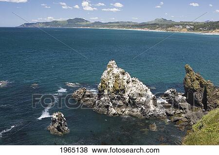 rock formation in the blue water along the coast at cape foulweather; oregon united states of america View Large Photo Image Stock Photo - rock formation in the blue water along the coast at cape foulweather; oregon united states of america. Fotosearch