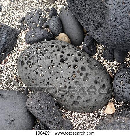 Stock Image - rocks with holes in them; galapagos, equador. Fotosearch