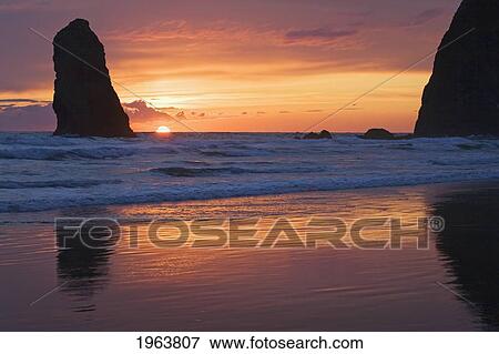 silhouette of haystack rock and other rock formations at sunset; cannon beach, oregon, united states of america View Large Photo Image Stock Photo - silhouette of haystack rock and other rock formations at sunset; cannon beach, oregon, united states of america. Fotosearch