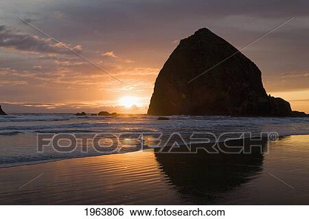 Stock Photograph - silhouette of haystack rock at sunset; cannon beach, oregon, united states of america. Fotosearch
