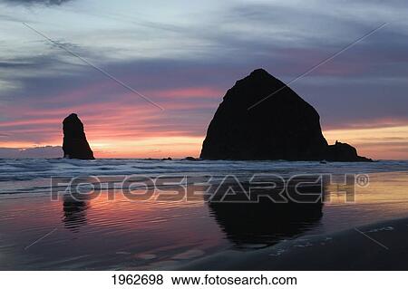 silhouette of rock formations and haystack rock at sunset; cannon beach, oregon, united states of america View Large Photo Image Stock Photo - silhouette of rock formations and haystack rock at sunset; cannon beach, oregon, united states of america. Fotosearch
