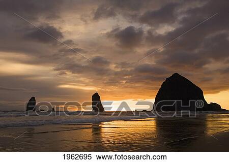 silhouette of rock formations and haystack rock at sunset; cannon beach, oregon, united states of america View Large Photo Image Stock Photography - silhouette of rock formations and haystack rock at sunset; cannon beach, oregon, united states of america. Fotosearch
