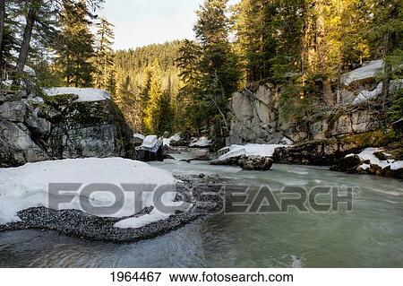 snow covered rocks on the shoreline of a river; whistler, british columbia, canada View Large Photo Image Stock Photo - snow covered rocks on the shoreline of a river; whistler, british columbia, canada. Fotosearch