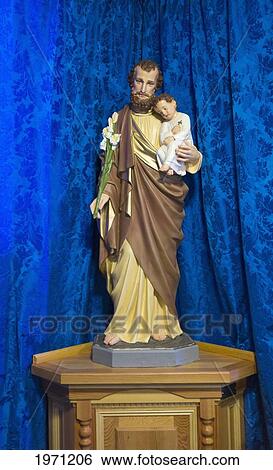 statue of jesus holding a child in front of a blue curtain; northumberland england View Large Photo Image Stock Photograph - statue of jesus holding a child in front of a blue curtain; northumberland england. Fotosearch