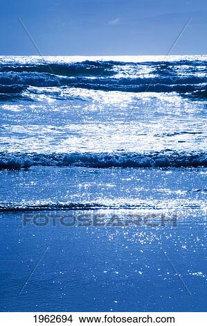 sun reflecting off the waves in the ocean; cannon beach, oregon, united states of america View Large Photo Image Picture - sun reflecting off the waves in the ocean; cannon beach, oregon, united states of america. Fotosearch