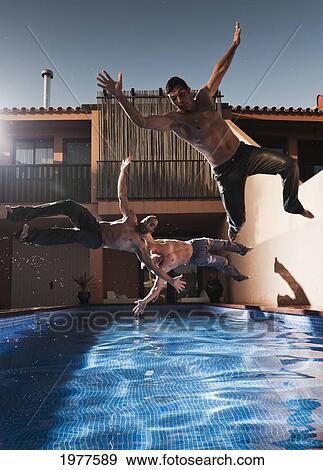 three men jumping into a pool wearing their pants; tarifa cadiz andalusia spain View Large Photo Image Stock Photo - three men jumping into a pool wearing their pants; tarifa cadiz andalusia spain. Fotosearch