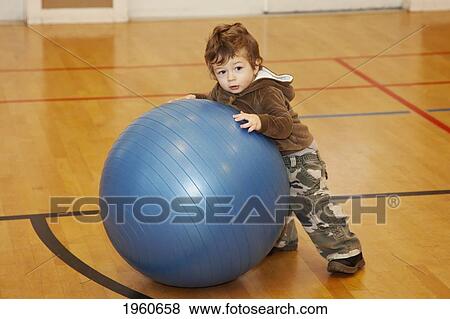 Stock Photo - toddler boy playing on an exercise ball; langley, british columbia, canada. Fotosearch