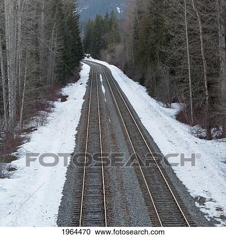 Stock Image - two sets of railroad tracks in the winter; whistler, british columbia, canada. Fotosearch