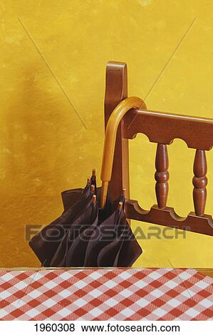 umbrella hanging off chair beside a table with red and white checked tablecloth and a yellow wall behind; torremolinos, malaga province, spain View Large Photo Image Stock Photo - umbrella hanging off chair beside a table with red and white checked tablecloth and a yellow wall behind; torremolinos, malaga province, spain. Fotosearch