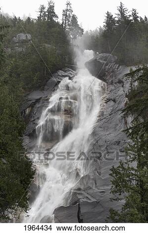 Picture - water cascading down the rock and forming a mist in jasper national park; alberta, canada. Fotosearch