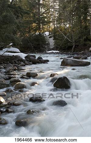 water frozen over the rocks in a river; whistler, british columbia, canada View Large Photo Image Stock Photograph - water frozen over the rocks in a river; whistler, british columbia, canada. Fotosearch