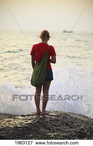 waves crash in front of woman on beach; koh tao, thailand View Large Photo Image Stock Photo - waves crash in front of woman on beach; koh tao, thailand. Fotosearch